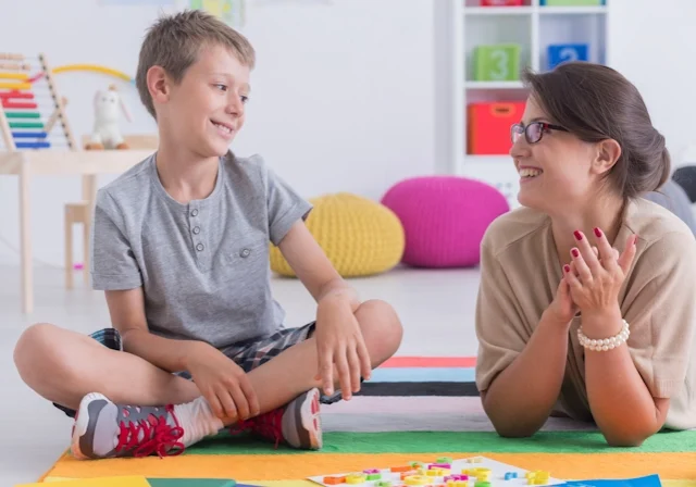 A boy participates in play therapy with a registered play therapist